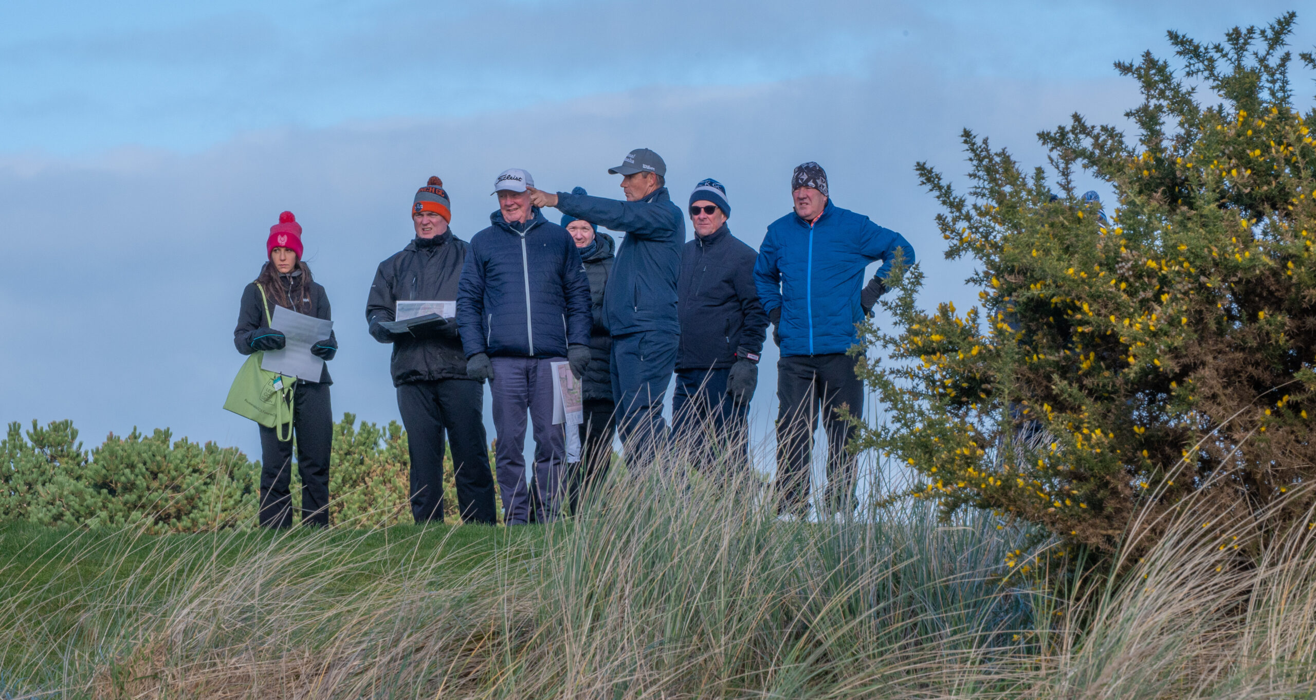 Pádraig Harrington, Giulia Ferroni and Genesis Links team reviewing plans on the links at Seapoint Golf Links