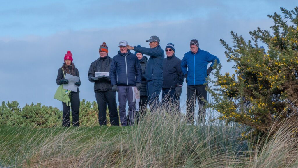 Pádraig Harrington, Giulia Ferroni and Genesis Links team reviewing plans on the links at Seapoint Golf Links